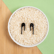 black stud earrings in bowl of rice