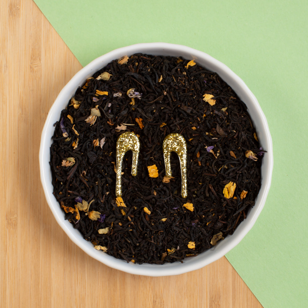 glittery gold stud earrings in bowl