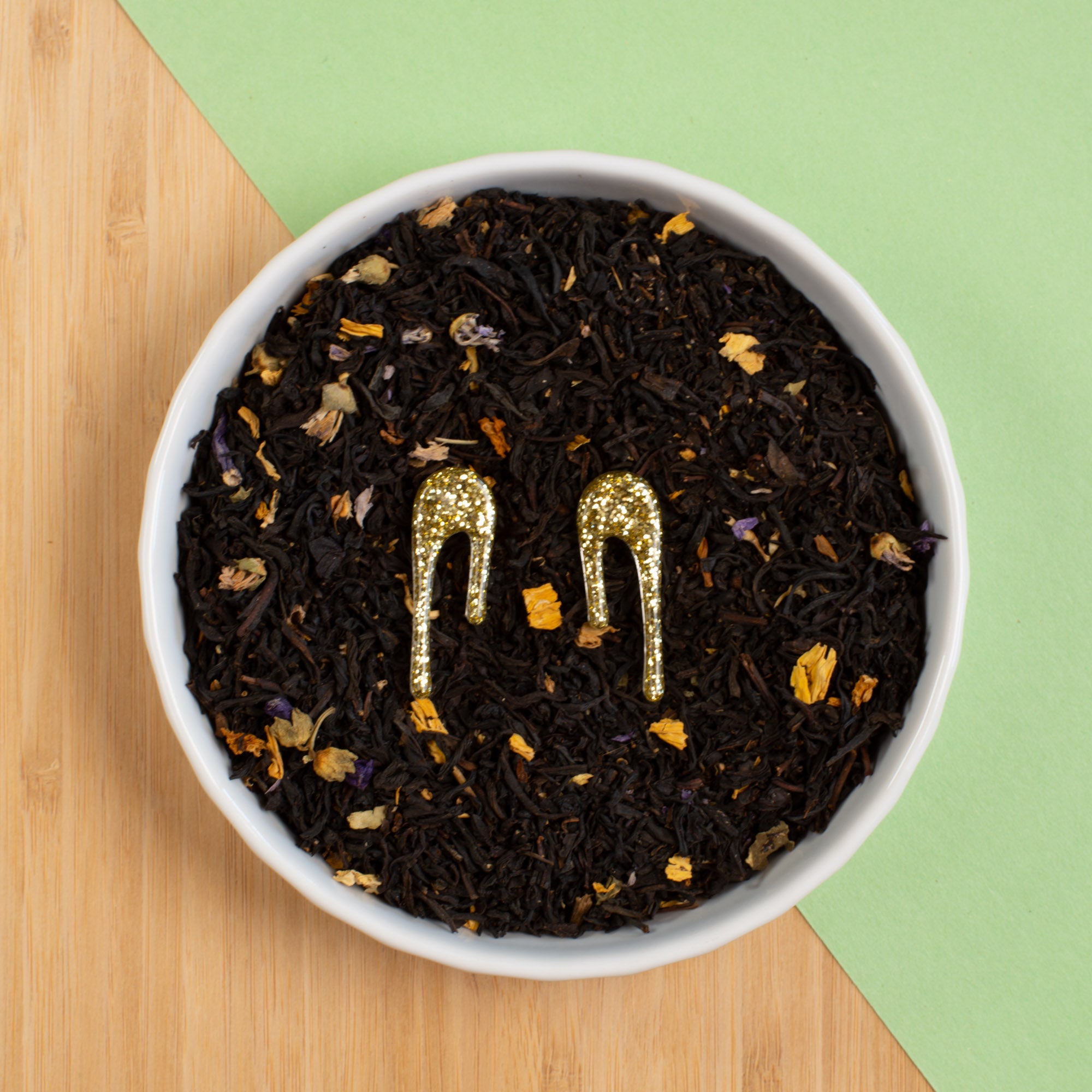 glittery gold stud earrings in bowl