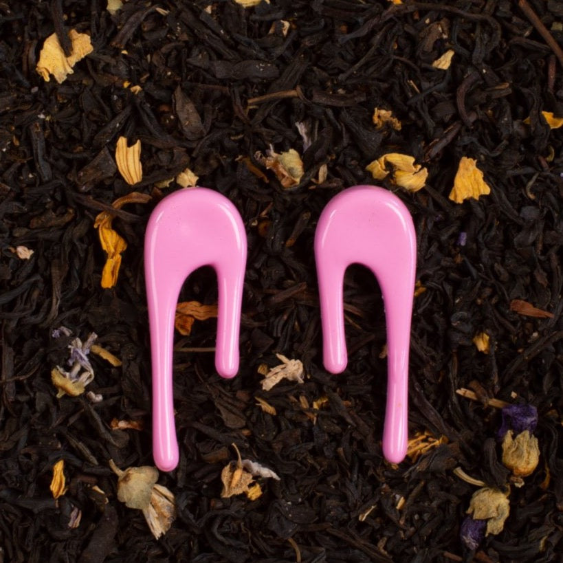Droplet pink stud earrings styled