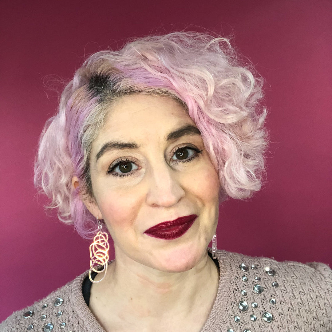 Iridescent dangle earrings on model