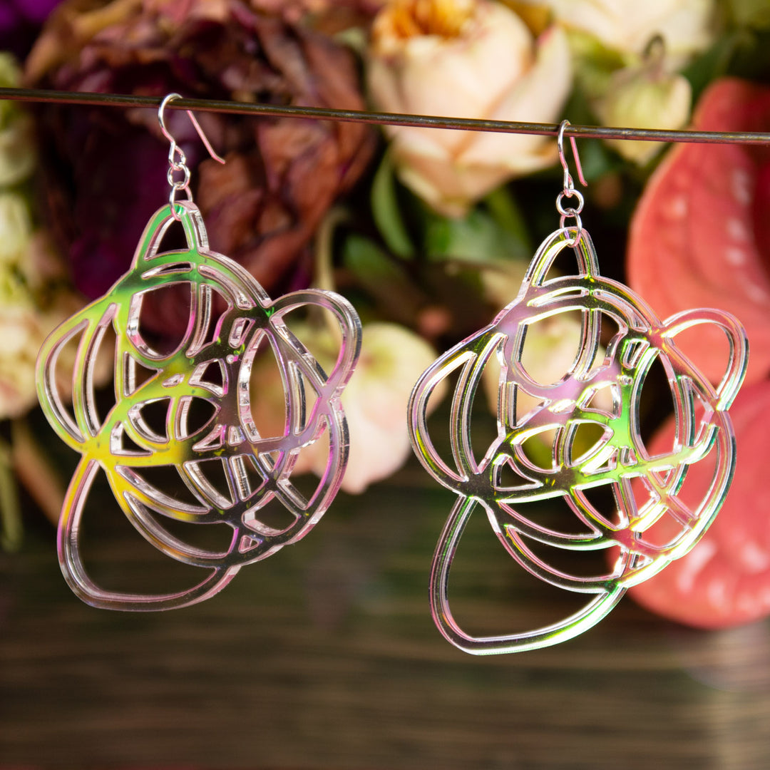 Lightweight iridescent earrings shown in front of colorful background