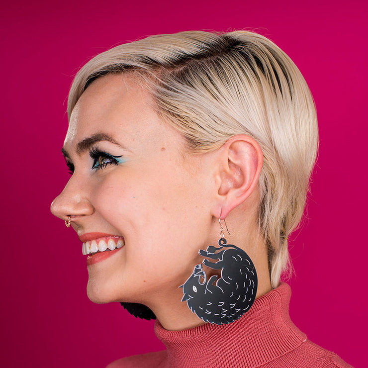 large black boar earrings on model