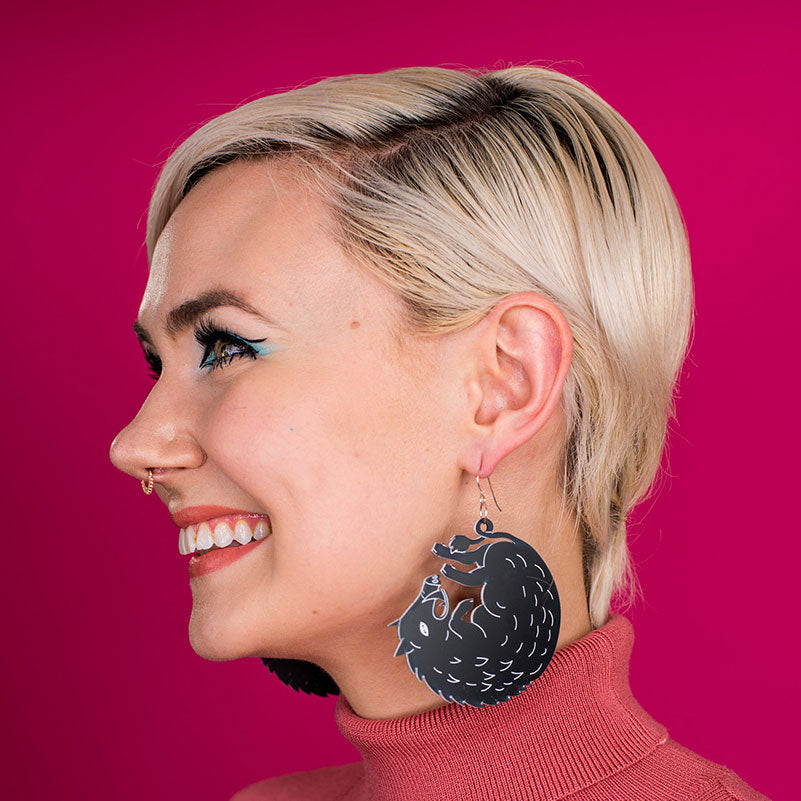large black boar earrings on model
