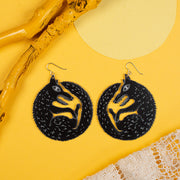 large black wolf earrings on yellow background