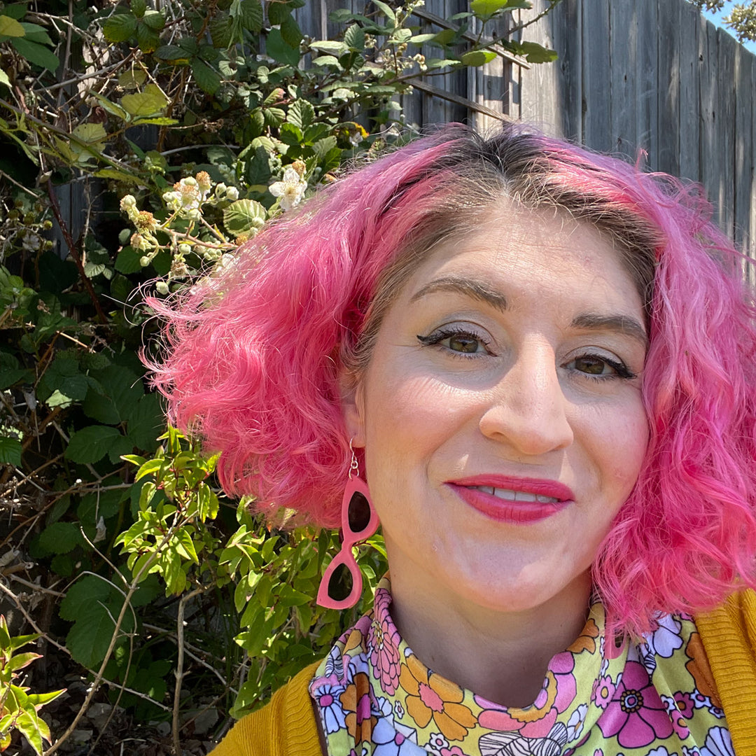 large pink earrings on model