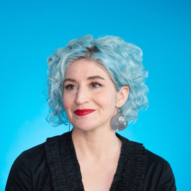 Model wearing small possum earrings