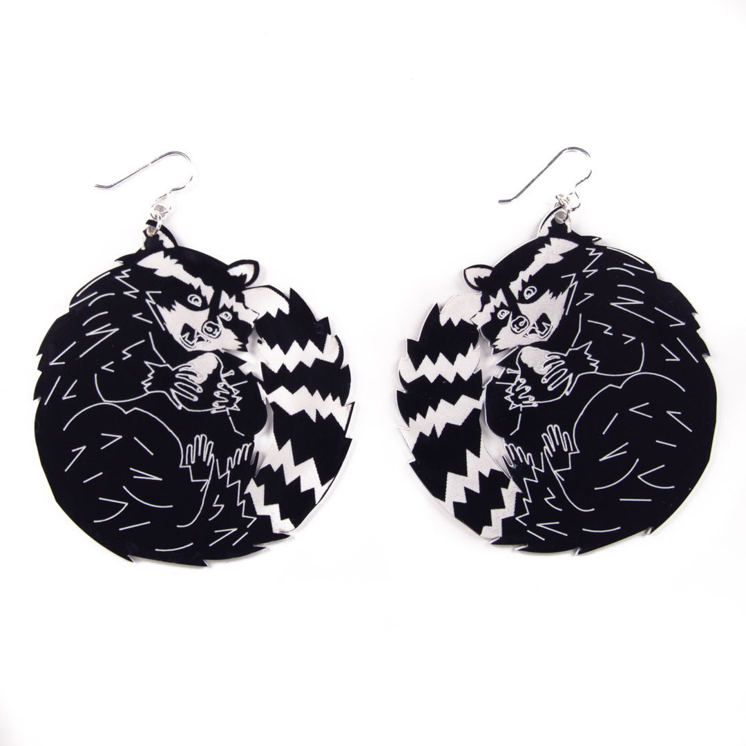 Big raccoon earrings on white background
