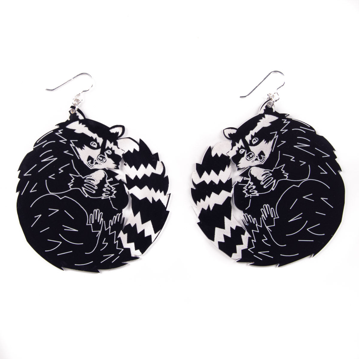 Big raccoon earrings on white background