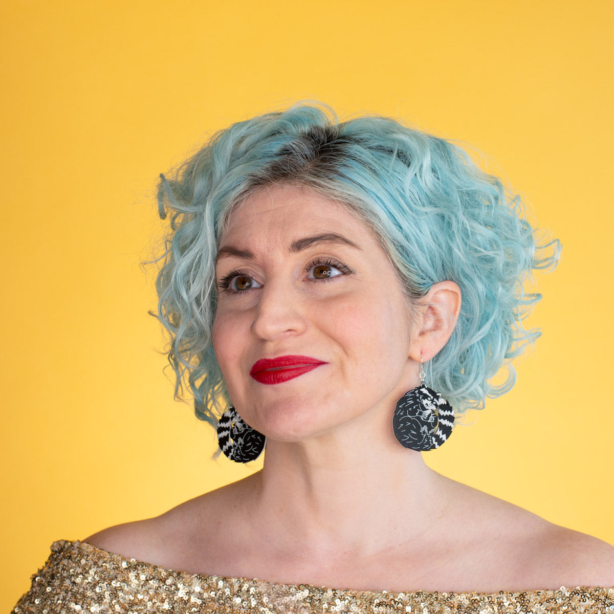 raccoon earrings on model