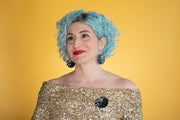 raccoon pin as modeled by a white woman with blue hair