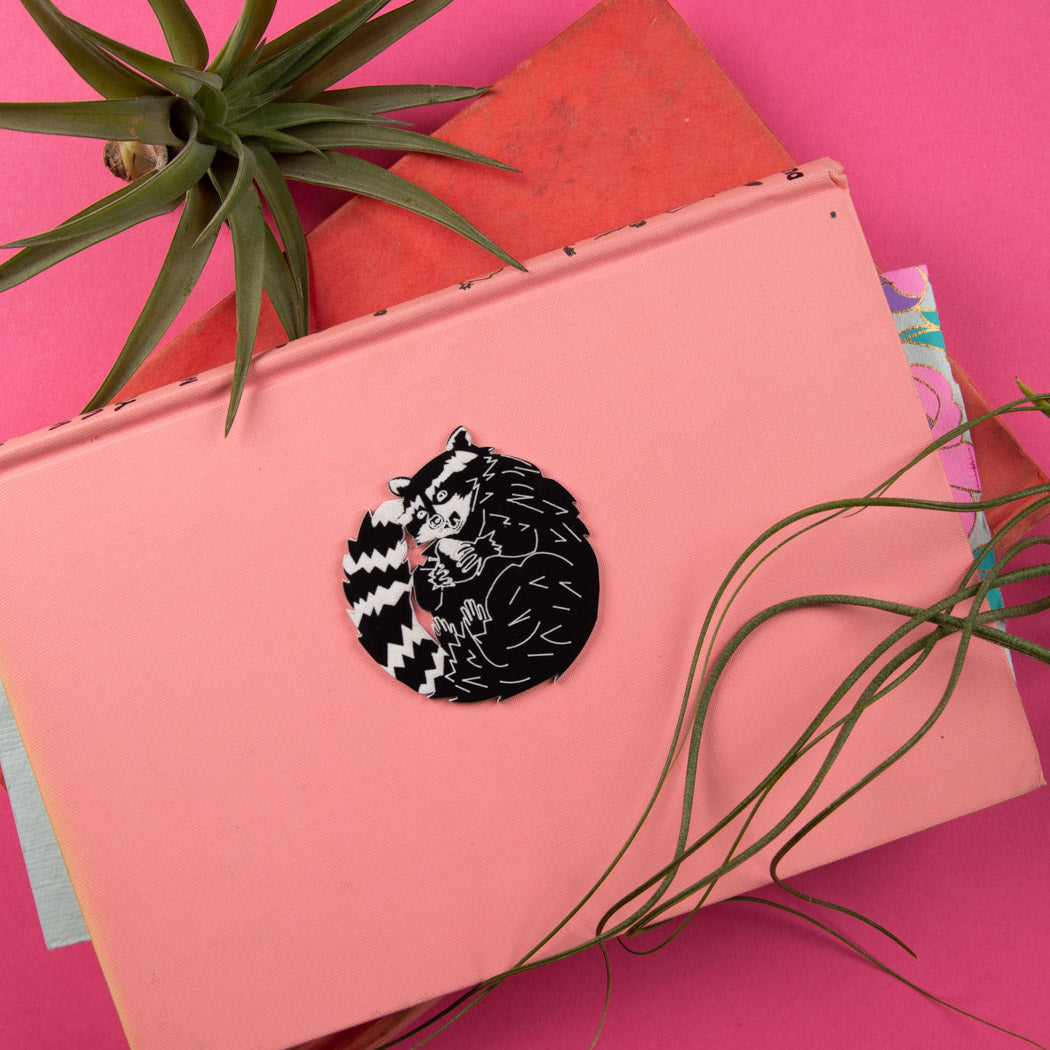 raccoon pin on pink background