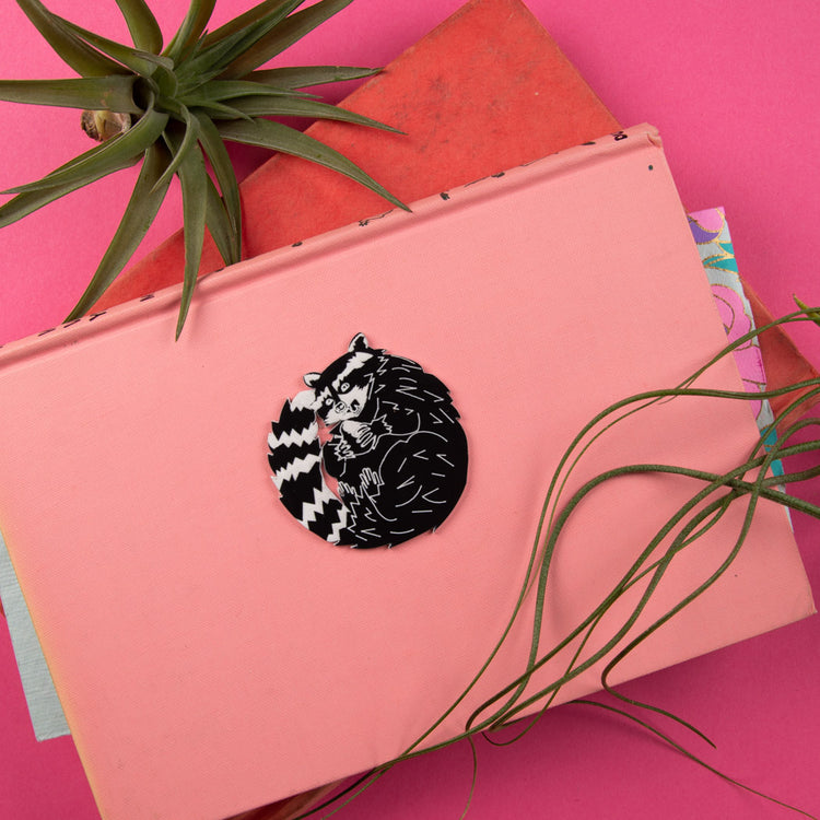raccoon pin on pink background