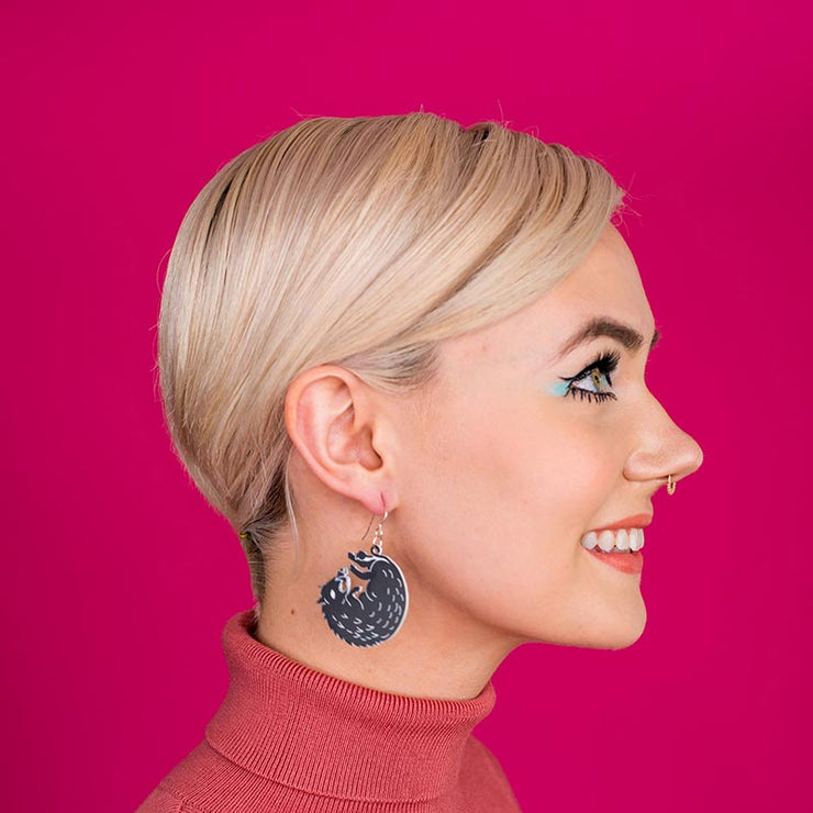 black boar earrings on model