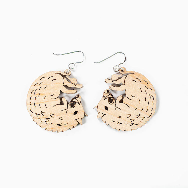 small wood boar earrings over white background