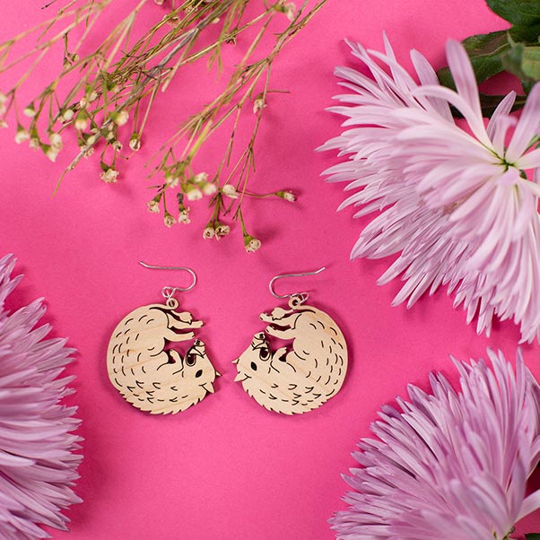 small wood boar earrings styled with flowers