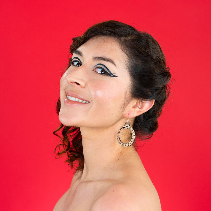 small wood ouroboros earrings on model