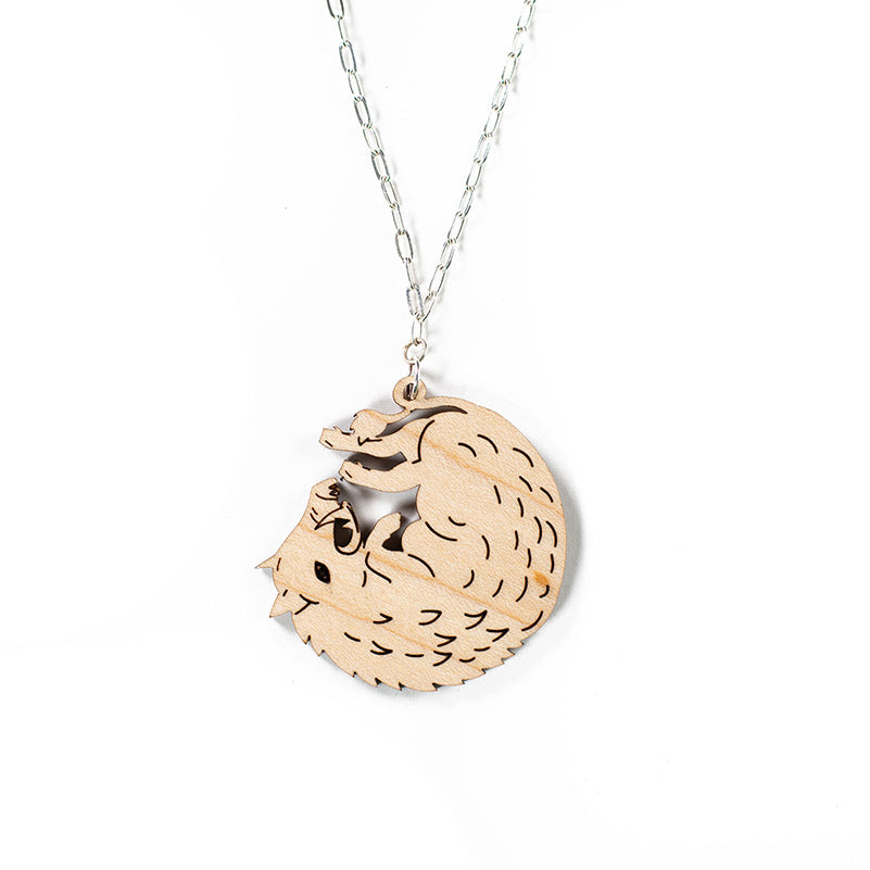 wood boar necklace over white background