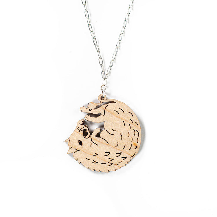 wood boar necklace over white background