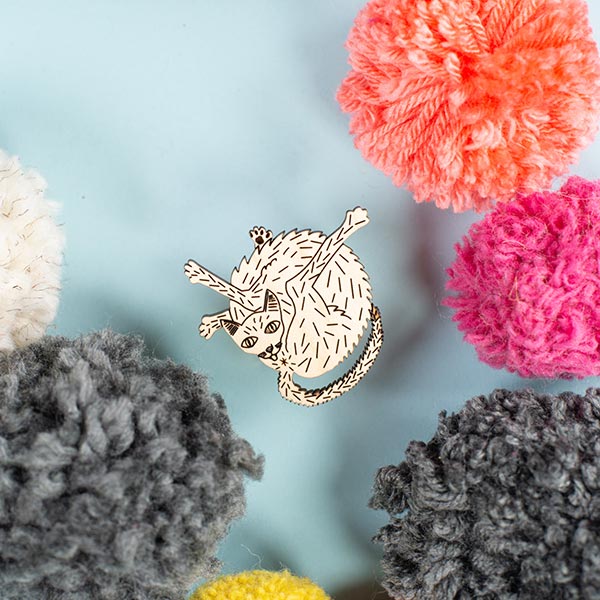wood cat pin styled with pom poms